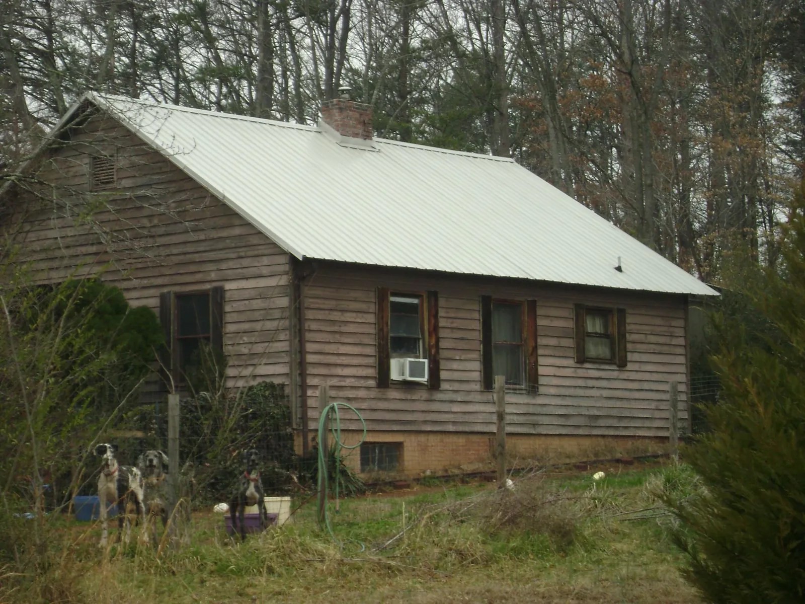 White metal roof on an old wood sided farmhouse, from a Metal Roof Installation job in Dover